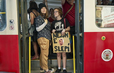 Two young women with a sign that reads: 'we are not blind', travel in a train following a rally which drew a quarter of a million people to Letna Park for the biggest protest since the communist era....