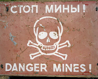 A sign in the Chartar 5 minefield warns, in Cyrillic and English, about the danger of unexploded mines . During the war between Armenia and Azerbaijan (1988 - 1994) both countries deployed large numbe...