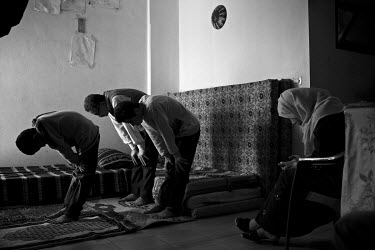 Mohammad Aldalou (10) leads the prayers with his father Naim Aldalou (53), his brother Omar (15) and seated, his Noor Aldalou (37). The family is from from the Palestinian refugee camp of Yamook in Sy...