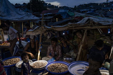 A market operating with the aid of solar powered lights in the Kutapalong mega refugee camp. Solar power has enabled some parts of the camp to operate after dark however, a majority of households (57%...