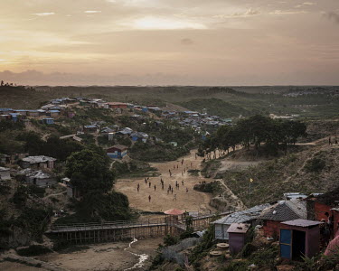 Children play beneath the setting sun in the Hakimpara Rohingya refugee camp.