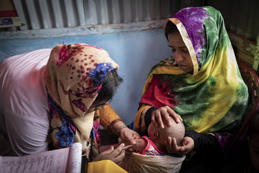 In a Primary Health Centre in Kutapalong Rohingya refugee camp 18, volunteer Nur-E-Jannat (18) helps Najuna and her young family receive the treatment needed, by making sure that their immunisations a...