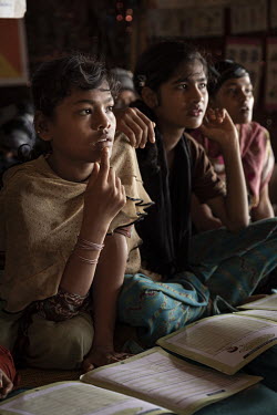 Rohingya refugee Rehana, who says ''I like school because I can learn something new each day'', listens during a lesson at an UNICEF learning space in Camp 18, in the Kutapalong mega refugee camp. Reh...