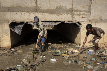 Men cleaning rubbish from a drainage channel at the Kutapalong Rohingya refugee camp.