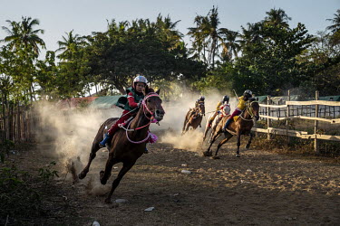 Child jockeys race horses around the first bend in a preliminary round of the 'Regional Police Chief's Cup 2019'.Racing is deeply rooted in the island's culture but the use of children, usually aged b...