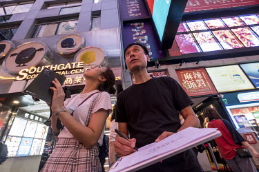 Assistant Professor Brian Kwok of the Hong Kong Polytechnic University, and his assistant Kiki Yau, document some of the last remaining neon signs in the Tsim Sha Tsui neighbourhood. Kwok is one of th...