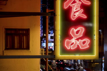 A sign for the Hong Kong Cafe hangs over Tung Choi Street in Mong Kok. The city's neon signs have been disappearing over the past decade, due to government regulations and the emergence if cheaper LED...