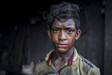 A child labourer in a workshop producing parts for the ship building industry. Child labour in Bangladesh is common, with 4.8 million or 12.6% of children aged 5 to 14 in the workforce.
