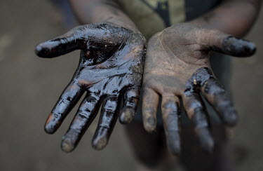 A child labourer in a workshop producing parts for the ship building industry holds up his oil stained hands. Child labour in Bangladesh is common, with 4.8 million or 12.6% of children aged 5 to 14 i...