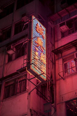 A large neon sign casts a glow over surrounding buildings on Portland Street, one of the last places in Hong Kong to see a significant number of neon lights.