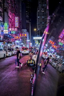 Portland Street in the Mong Kok neighbourhood, glows with reflected neon lights after a rainstorm. The street is one of very few that still retain a number of neon signs.