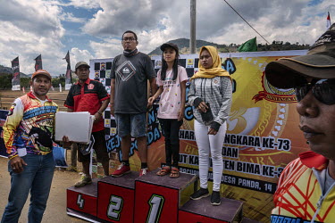 Owners and their family members stand on a podium to received their prizes after being placed in the final of the 'Regional Police Chief's Cup 2019'.  Racing is deeply rooted in the island's culture b...