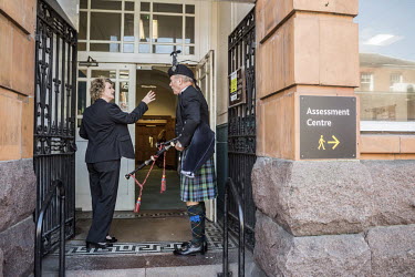 A Scottish bag piper being briefed about the timing of a wedding at the registry office, in the town council building.   In the 2016 referendum on Britain's position within the EU, the Boston district...