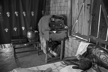 A man sleeps on a bed inside Juba Weigh Station which was converted into a refugee camp for Internally Displaced People who fled fighting in late 2014.