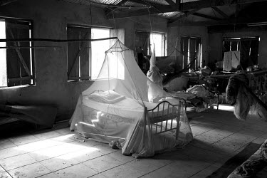 A bed covered by a malaria net inside Juba Weigh Station which was converted into a refugee camp for Internally Displaced People who fled fighting in late 2014.