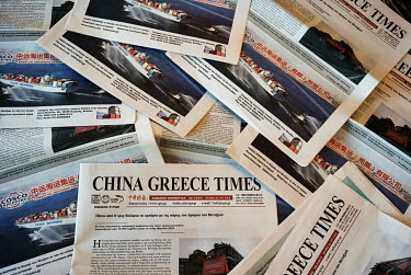 Free copies of the China Greece Times newspaper at the Athenaeum Grand Hotel.