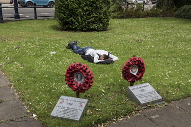 An Eastern European migrant labourer sleeps on a patch of grass at the town's war memorial. Beside him are two plinths and wreaths of poppies, memorials to World War 1 battles.  In the 2016 referendum...