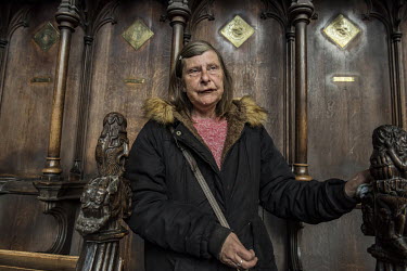 Carol, a cleaner in St Botolph's Church, the symbol of Boston, stands in the choir stalls. Carol claims to have been sexually assaulted by a migrant, the marks still on her body. She wants another ref...