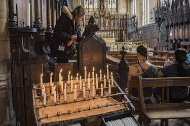 Carol, a cleaner in St Botolph's Church, the symbol of Boston, polishes the choir stalls. Carol claims to have been sexually assaulted by a migrant, the marks still on her body. She wants another refe...