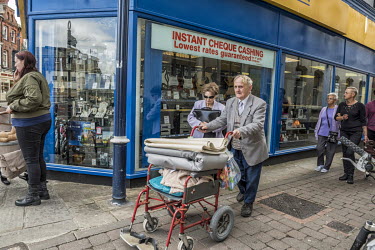 An elderly couple pass a pawn shop.  In the 2016 referendum on Britain's membership of the EU, the Boston district produced the highest pro-Brexit vote, 75.6% per cent of the popular vote on a high tu...
