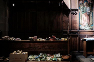 Bread, fruit and vegetables are laid out on pews at the food bank at St Aidan's Church, run by the Rev. Gemma Sampson.