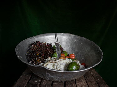 Metal bowl on a table in Nadine's house with palm nuts, mushrooms, mashed cassava and avacados. All the items were bought from the local market that day to make a family meal. Nadine explains, 'our da...