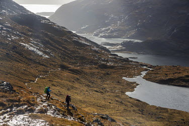 Walkers make the challenging descent to Loch Coruisk and the Bad Step between Sligachan and the Camasunary bothy with the Cuillin ridge hidden in the clouds above.