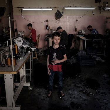 Mohammed Nour Abdullah in the workshop in Duztepe where he works 12 hours a day, Monday to Saturday making jeans for 50 Turkish Lira (ca Â�10.70) for his 72-hour week. Mohammed and his family are Syr...