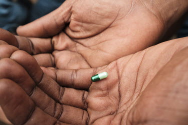 A tramadol capsule with a stated dosage of 120mg, a type commonly found on the streets, in the hands of a roadside coffee seller. Some drinks vendors sell the opioid painkiller in addition to beverage...