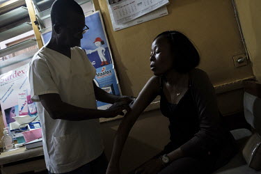 Lucas Kpogli administering a 100mg dose of tramadol, an opioid painkiller, to Grace Kudzu at his infirmary. Grace suffers from sickle cell disease, during a 'sickle cell crises', which in Grace's case...