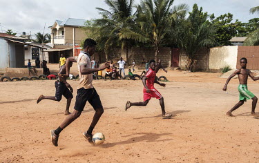Ayao (not his real name) with the ball during an informal neighbourhood football tournament. The 15 year-old is addicted to tramadol, a prescription-only opioid analgesic. In West Africa there is a pr...