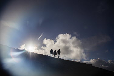 Walkers silhouetted on the Trotternish Ridge near Lealt on the northern section of the Skye trail.
