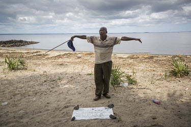 A retired lieutenant, with the aid of a hand drawn map, offers his services as a guide to the mouth of the Congo River. The other side of the river is Angola.