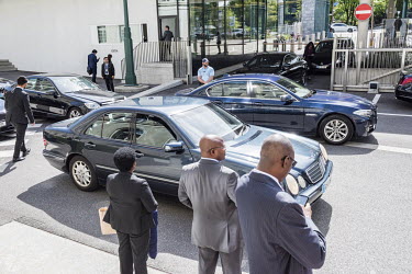 Diplomats, limousines and security at the entrance to the WTO headquaters following a session of the General Council, the institution's highest-level decision-making body.  The World Trade Organisat...
