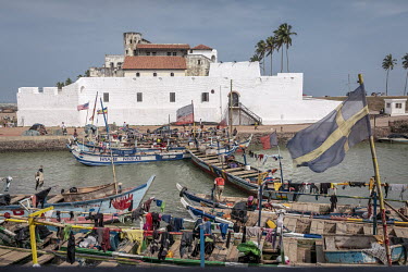 Fishing boats moored beneath Elmina Fort.