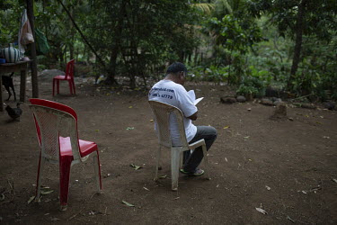 David Choc, former insurgent guerrilla and currently a human rights advocate and Mayan spiritual guide, reads outside his home.