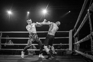 Lucas Marshall, from Brazil, defends himself during his victorious bout against Latvian Tadas Ruzga at the Ultimate Bare-Knuckle boxing competition at Manchester's Bowlers Exhibition Centre, Old Trafford.