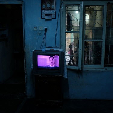 An old television broadcasts a show in the home of Wardeh (25), a Syrian widow, now living in a small, spartan apartment in Duztepe, one of the poorest districts in Gaziantep.