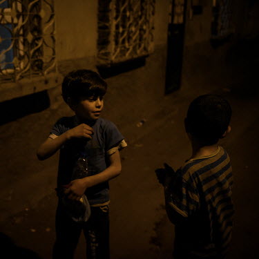 Two brothers, refugees from Aleppo, Syria, aged six and seven return to their family's home after finishing their shift at a factory where they make jeans. They work a 72 hour week, 12 hours a day, Mo...