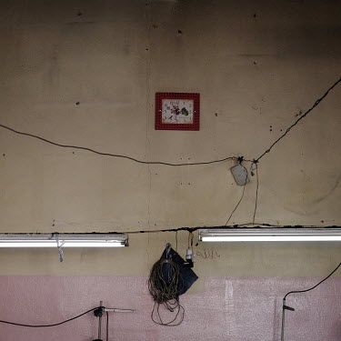 A clock hangs on the wall in a workshop at a jeans factory where employed among the labour force are Syrian child refugees who work 12 hours a day for 50 Turkish Lira (approx. GBP 7.00).