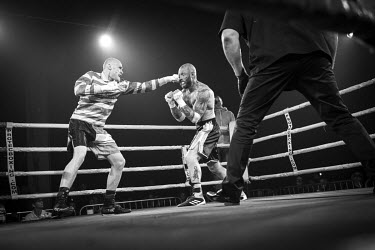 Chris Wheeldon (centre), who won his fight against Seamus Devlin (left), takes a punch at the Ultimate Bare-Knuckle boxing competition at Manchester's Bowlers Exhibition Centre, Old Trafford.