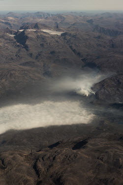 Sea fog meets tundra fires below a glacier near Sisimiut.