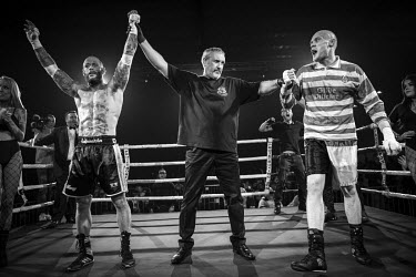 The referee raises Chris Wheeldon's arm to signal his victory over Seamus Devlin following their bout at the Ultimate Bare-Knuckle boxing competition at Manchester's Bowlers Exhibition Centre, Old Tra...
