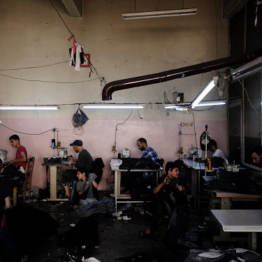 A workshop at a jeans factory where children are employed alongside other refugees working a 72 hour week, 12 hours a day, for 50 Turkish Lira (approx. GBP 7.00).