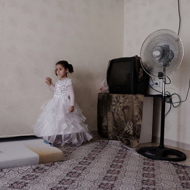 Meryem (4) a Syrian refugee child and the daughter of a woman who was married at 14. She is wearing an outfit for an upcoming wedding and like many girls will face pressure to do the same.