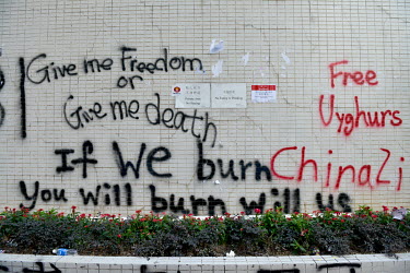Graffiti sprayed by anti-China, pro-democracy activists reads; 'Give me Freedom or Give me death', 'If we burn you will burn with us' and a graffiti referencing China's treatment of its Uyghur minorit...
