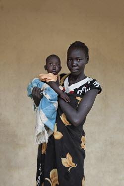 Ator Gareng with her baby who is being treated at a mother and baby nutrition clinic for malnourished children.