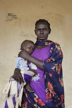 Arek Dau with baby Wal Uol Garang who is being treated at a mother and baby nutrition clinic for malnourished children.