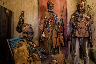 A group of Dozo hunters from the Bambara ethnic group armed with various weapons and wearing protective amulets. A pan-ethnic society that have long existed across several West African countries, grou...