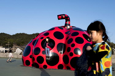 A large art installation of a red pumpkin by artist Yayoi Kusama at the Benesse Art House as part of the Setouchi Triennial contemporary art festival beside the Seto Inland Sea.